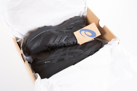 Bordeaux, Aquitaine France - 12 20 2021: Asics logo brand and text sign on sell box sport sneaker black trail of Japanese multinational footwear corporation shoesのeditorial素材