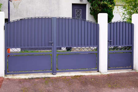 portal old gray classic metal home gate at entrance of house garden gray door