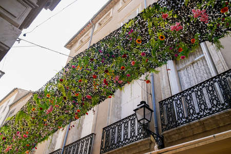 beautiful artistic decorations plastic flower artificial flowers hanging on the streetの写真素材