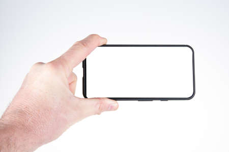 Smartphone in hand holding new phone Technology smart phone with blank white empty screen and modern...