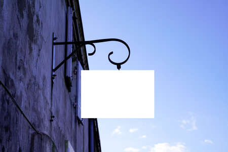 Blank white empty vintage mockup signboard on facade shop wallの写真素材