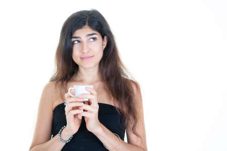 attractive girl holding coffee hot drink white cup looking aside in white backgroundの写真素材
