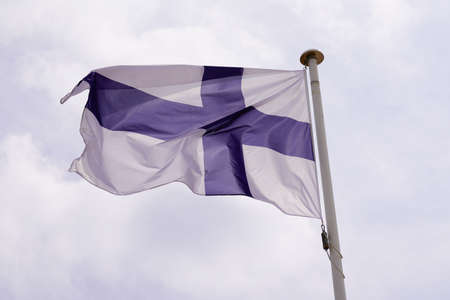 finland flag finnish National state flag on wind mat with blue cloud skyの写真素材