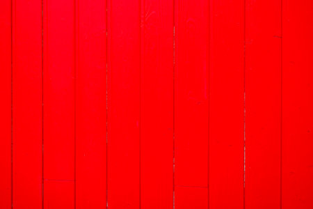 wooden wall fence red wood house made of plank boards vertically Background