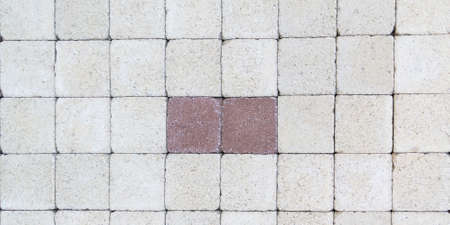 white abstract pattern background of gray red cobblestone pavement in close-up top view
