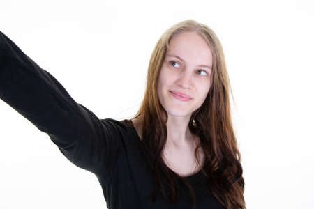 Young blond woman making smartphone selfie picture with cellphone over isolated white background
