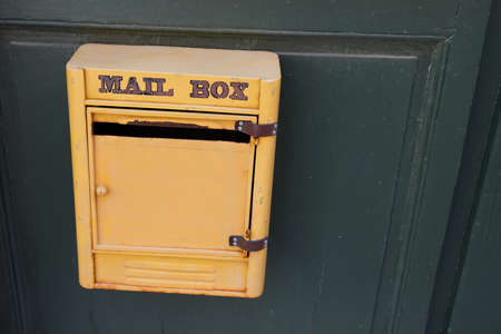 mail post text sign on yellow old private mailbox of vintage houseの写真素材