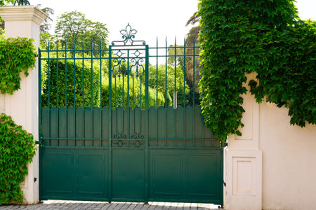 green vintage house gate and garage door to access home garden