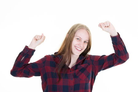 Joyful happiness woman celebrating success pumping fists in success concept isolated on white backgroundの写真素材