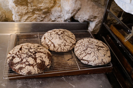 Round breads french loaves on shelves in shop Baked goods whole grain bread