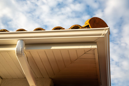 Rain gutter system corner gutters drainage system downpipe on the roofの写真素材