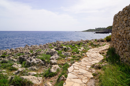 cobblestone path coast access beach mediterranean sea in south Antibes Juan-les-Pins France southeastの写真素材