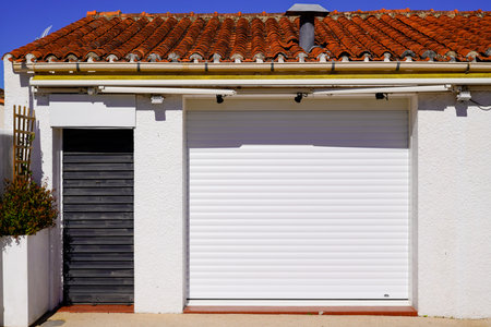 modern private house suburb with garage white gate and door gray entranceの写真素材