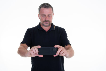 man making smartphone selfie with cell phone camera on white background middle aged handsome guy...