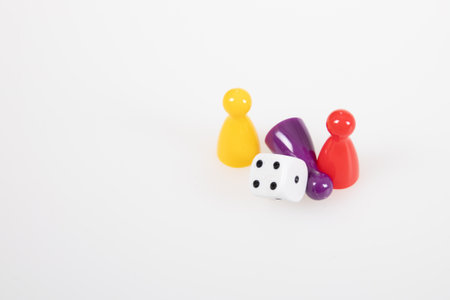 Board game concept colorful pawns with a six sided diceの写真素材