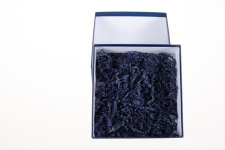 carton blank square box blue wood shavings chips yellow thin recycled with closed lid on white backgroundの写真素材