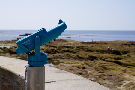 tourist beach binocular tourist pay to view in telescope in ocean coast horizon