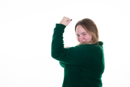 overweight woman smiling happiness powerful flexing muscular biceps arm in white backgroundの写真素材