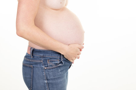 pregnant woman hands on belly on white background