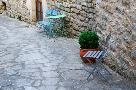 vintage metal wooden chair and table in the medieval old street