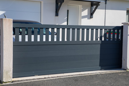 portal slide gray aluminum large car home gate gray modern facade house in street suburbの写真素材