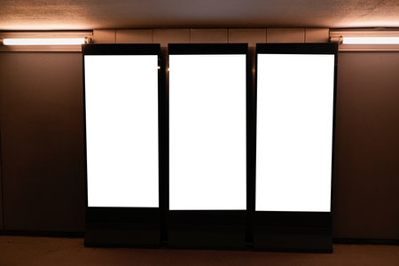Three blank billboard advertising space on wall for mock up digital advertising placement templateの写真素材