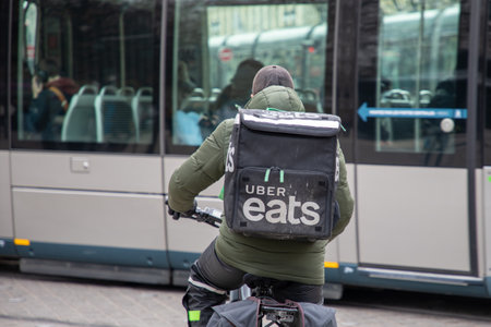 Bordeaux , Aquitaine France - 03 05 2023 : Uber eats bike delivery man bike with text sign and brand logo on back large backpackのeditorial素材