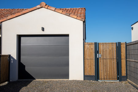 Modern Home gray split sequential gate garage portal gray facade of house suburb with wooden door access gardenの写真素材