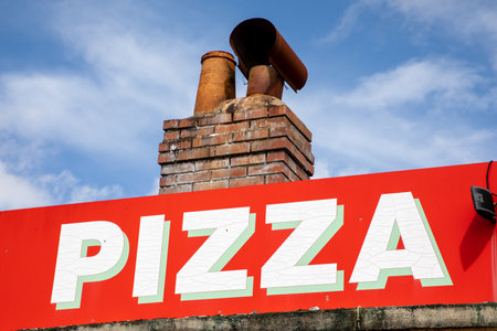 pizzeria restaurant sign pizza text on wall facade italian style restaurantの写真素材