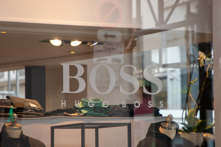 lyon , Aura France - 04 27 2023 : Hugo Boss logo brand chain and text sign facade shop luxury storefront windows clothes boys men in store Germanのeditorial素材