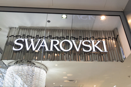 lyon , Aura France - 04 27 2023 : Swarovski logo brand and text store Austrian producer of jewelry luxury cut lead glass crystal sign facade boutiqueのeditorial素材