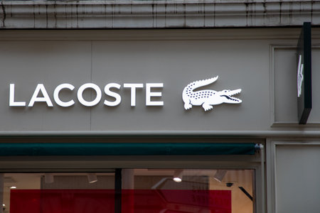 Bordeaux , Aquitaine France - 05 09 2023 : lacoste logo brand and text sign on wall facade shop entrance in cityのeditorial素材