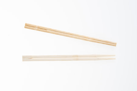wooden chinese chopsticks isolated on white backgroundの写真素材