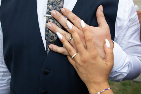 Rings for wedding in blue bride dress with groom fingers hands in romance love marriage dayの写真素材