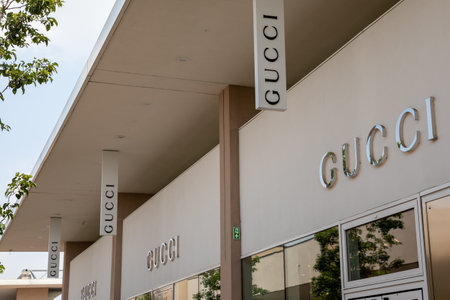 Milan , Italy - 07 15 2023 : Gucci fashion signage facade store sign text and logo Italian luxury brand of fashion and leather good in giant letters entranceのeditorial素材