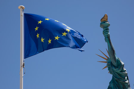 Statue of Liberty with flag of European Union EU in blue sky in mast with blue background and...