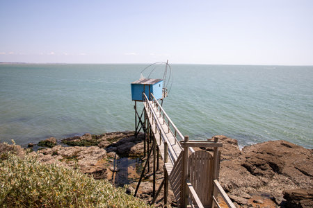 Fishing hut wooden in low tide atlantic ocean water sea Saint-Palais-sur-Merの写真素材