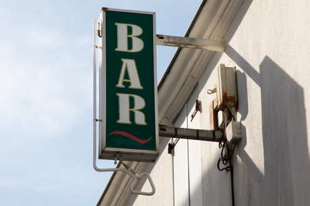 bar sign text board on wall pub facade green with neon arrowの写真素材