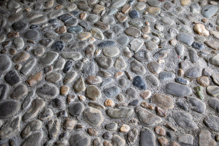 Old pebble stone gray wall of gray floor brick horizontal backgroundの写真素材