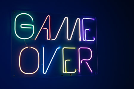 game over neon sign color on a dark wall backgroundの写真素材
