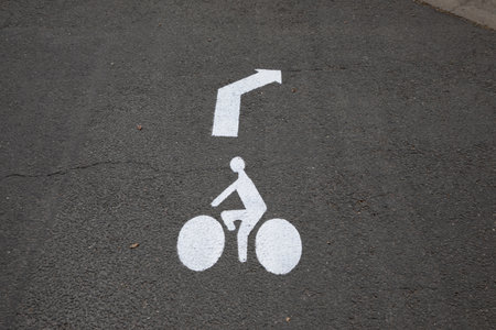 cycle path with arrow painted on the asphalt roadの写真素材