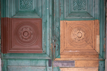 door wooden restoration on facade building new wood part in street viewの写真素材