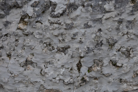 Old ancient stone wall cement background facade horizontal stones wallpaperの写真素材