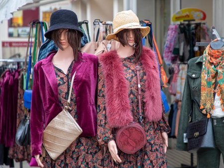 plastic mannequin in front of the entrance to the clothing store in city streetの写真素材