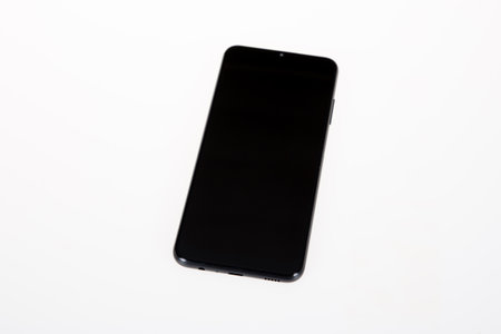 New cell phone with black empty mockup smartphone screen over white isolated background