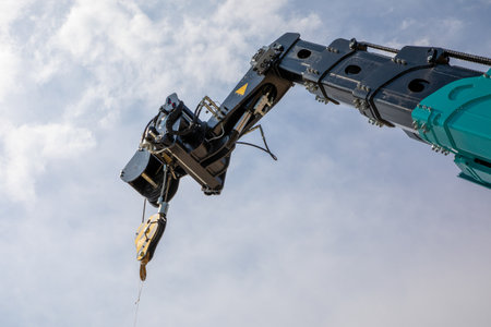 Cargo crane industrial detail level high in use in blue sky and clouds
