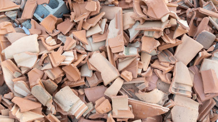 Rubbish Bricks tile on Construction Site Broken terracotta tiles from burnt roof smashed clay red tilesの写真素材