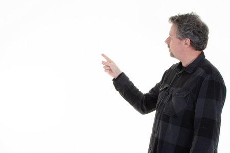 cheerful middle aged businessman pointing finger hand at copy space for advertising on white backgroundの写真素材