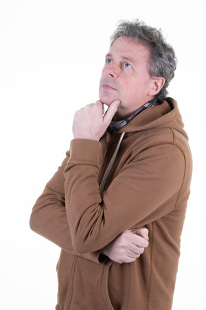 Middle aged white man in hoodie thinking looking up on white backgroundの写真素材