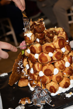 French dessert croquembouche wedding cake on the tableの写真素材